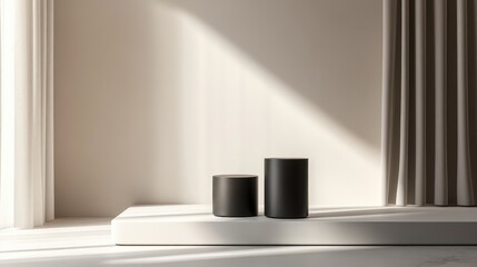 Modern minimalist interior featuring two black cylindrical vases on a white ledge with soft natural light and draped curtains Copy Space