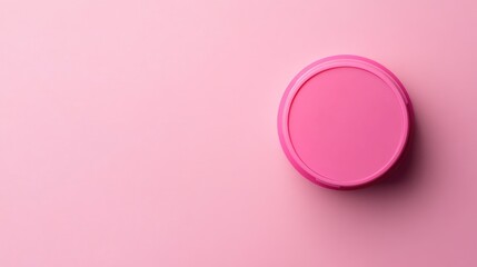 Pink round container lid on a soft pink background with ample copy space for text insertion