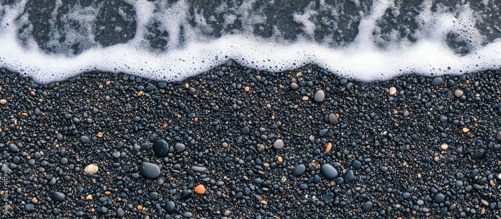 Poster black sand beach texture with wave patterns and copyspace for text over dark sandy shoreline backgro