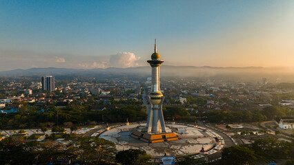 Aerial photo of the religious monument which is one of the icons in Kendari, Southeast Sulawesi, Indonesia at sunset. Panoramic view around the monument with residential and urban background at dusk