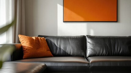 Stylish leather couch adorned with orange artwork in a modern, neutral-toned living space showcasing contemporary home decor and spacious layout.