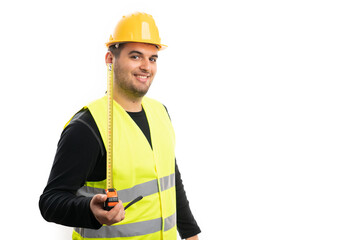 Friendly builder man presenting tape measure with copyspace