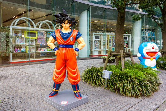 Tokyo, Japan - November 15, 2024: A life-sized statue of Goku from the anime &lsquo;Dragon Ball&rsquo; and Doraemon from the iconic Japanese series &lsquo;Doraemon,&rsquo; displayed outside a Bandai Namco toy store in Tokyo.
