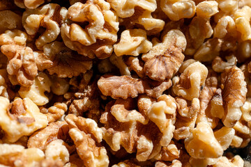 A detailed close-up of shelled walnuts, showcasing their rich texture, natural color, and nutritional value under natural light.