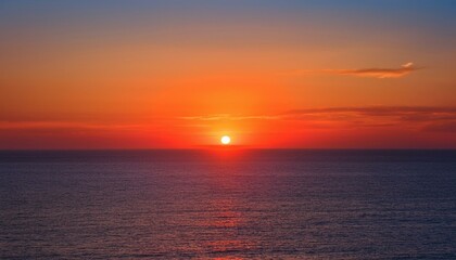 Obraz premium 멀리 수평선 위로 떠오르는 선명한 일출, 붉고 따뜻한 색감의 태양