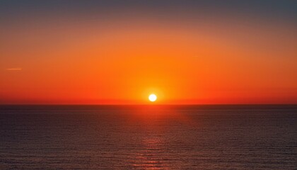 Fototapeta premium 멀리 수평선 위로 떠오르는 선명한 일출, 붉고 따뜻한 색감의 태양