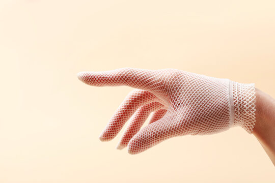 A young woman's hand in a white glove. Beautiful long fingers.