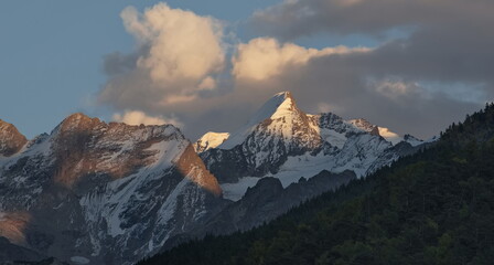 Russia. Kabardino-Balkaria. View of the snow-capped peaks of the Caucasus Mountains at sunset on an...