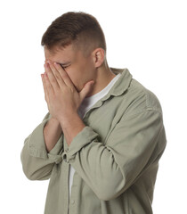 Distressed young man crying on white background