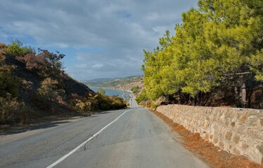 Russia, Republic of Crimea. View of the winding paved road along the Black Sea coast near the town of Sudak surrounded by picturesque mountains.