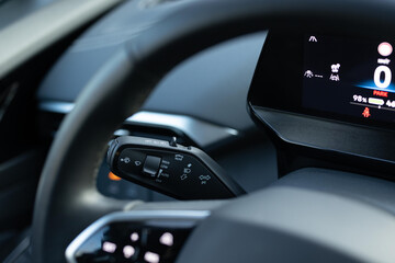 Handle with buttons windshield wiper turn signal, and washer in car. Detail of turning signal,...