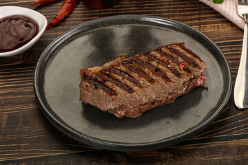 Grilled beef striploin steak with sauce