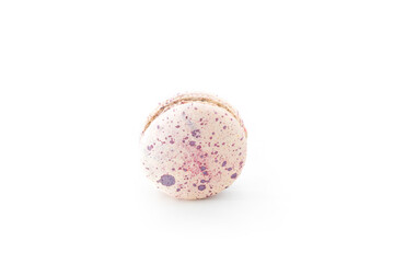 One white macaroon with purple spots isolated on white background. Tasty colorful macaron. Delicious dessert. French pastry made from egg whites. Culinary and cooking concept.