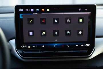 Dashboard display screen with multimedia in a new luxury vehicle. Car control dashboard. New car interiors. Elegant modern navigation display. Part of vehicle. Car design Multimedia information