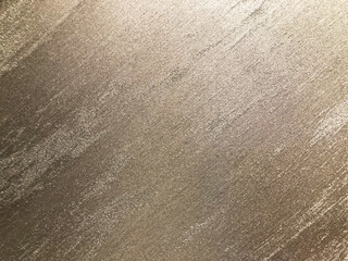 Close-up of textured goldenyellowish surface with 3D appearance, likely made from metal, fabric, or painted surface Subtle shadows due to lighting No background or texts visible