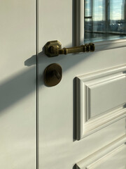 Close-up image of a white door with two locks traditional and electronic Light source from top left, casting shadows Utilitarian style, focusing on lock details