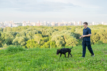 Man running with pit bull terrier outdoors. 