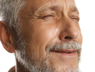 Sad senior man crying on white background, closeup