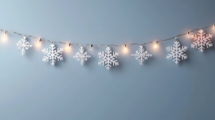A string of lit snowflakes decorates a pale blue wall, creating a cozy winter ambiance.