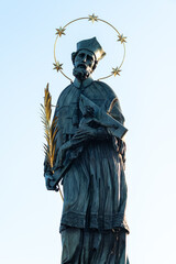 Statue of John of Nepomuk mounted to the balustrade of Charles Bridge in Prague, Czech Republic © Mirko