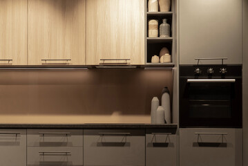Built-in black electrical oven integrated into modern kitchen cabinet