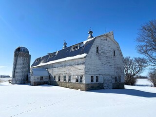 Old horse barn sits atop fresh snow