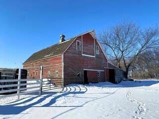 A classic English Gambrel style barn in the soft snow