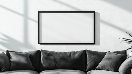   Living room features gray couch & hanging picture frame on the wall above