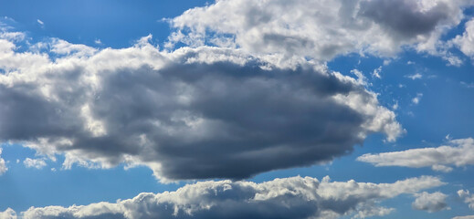 Obraz premium Blue sky with white clouds. The background is a clear blue sky without any cumulus clouds.