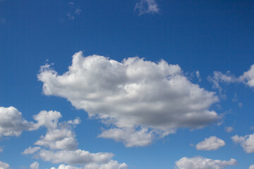 Blue sky with white clouds. The background is a clear blue sky without any cumulus clouds.