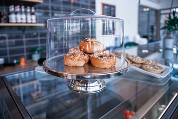 A Collection of Delicious Baked Goods Beautifully Displayed Under a Glass Dome for Viewing