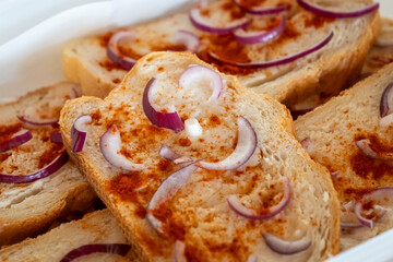 Traditional pork fat bread with onion slices and peppers