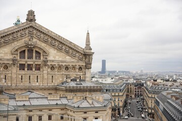 Ornate facade of Opera Garnier with Parisian streets and modern skyscraper view