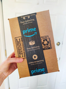 Amazon Prime delivery box in a hand.