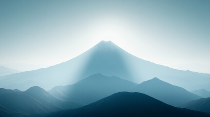 Fototapeta premium Silhouette of a volcanic peak against a clear sky with soft-focused mountains below, a minimalistic and bright tone creating an empty blank caption space on the side, evoking calm amidst chaos