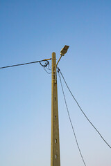 Streetlamp against the backdrop of a clear blue sky.