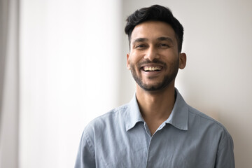 Shiny smile. Head shot photography portrait handsome smiling young dark haired male wearing casual...