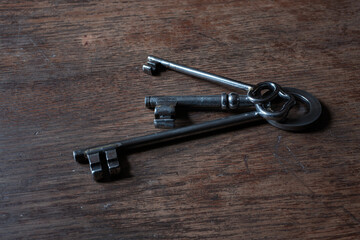 Old keys lying on a wooden tabletop