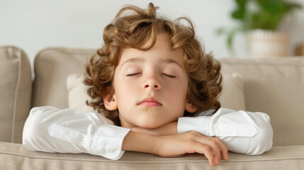Fototapeta premium A young boy peacefully sleeps on the sofa at home, worn out from a busy day at school and comforted by the TVs glow.