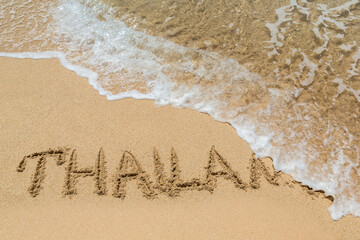 Thailand written in a sandy
