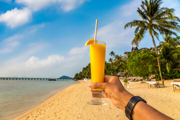 Hand holding a smoothie glass