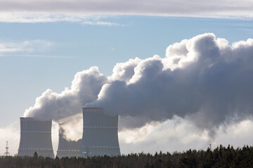 Nuclear power plant cooling towers with clouds of steam