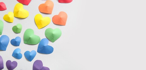 Colorful hearts made of paper on light background with space for text. LGBT concept