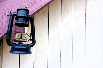 A Vintage Black Lantern Hangs Beautifully on a Rustic Wooden Wall Surrounded by History