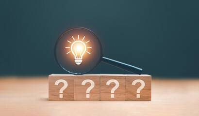 Creative thinking idea and problem solving concept. Wooden block with question mark icon and...