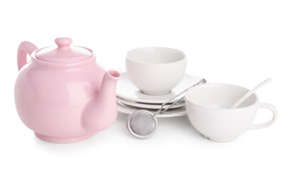 Ceramic teapot with cups, tea infuser and saucers on white background