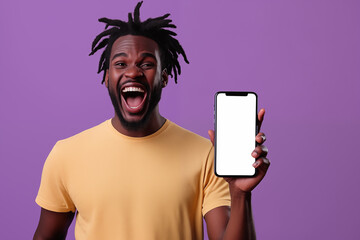 Photo of man showing a blank smartphone screen, wears a yellow t-shirt on the violet background.