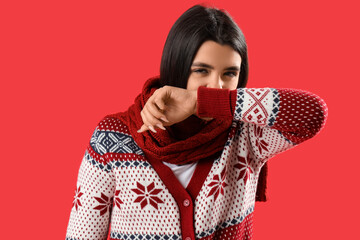 Sick young woman on red background