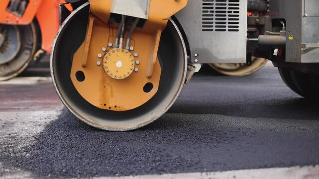 Roadworks, process of asphalting, blacktopping and paving new road layer, laying new asphalt road pavement, paver machine and steam roller compactor, city street construction site, vehicle working
