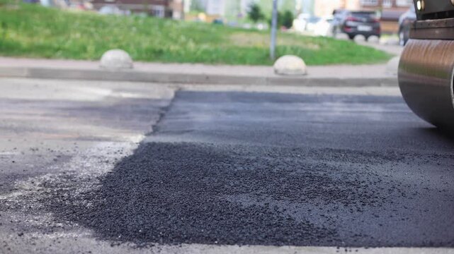Roadworks, process of asphalting, blacktopping and paving new road layer, laying new asphalt road pavement, paver machine and steam roller compactor, city street construction site, vehicle working
